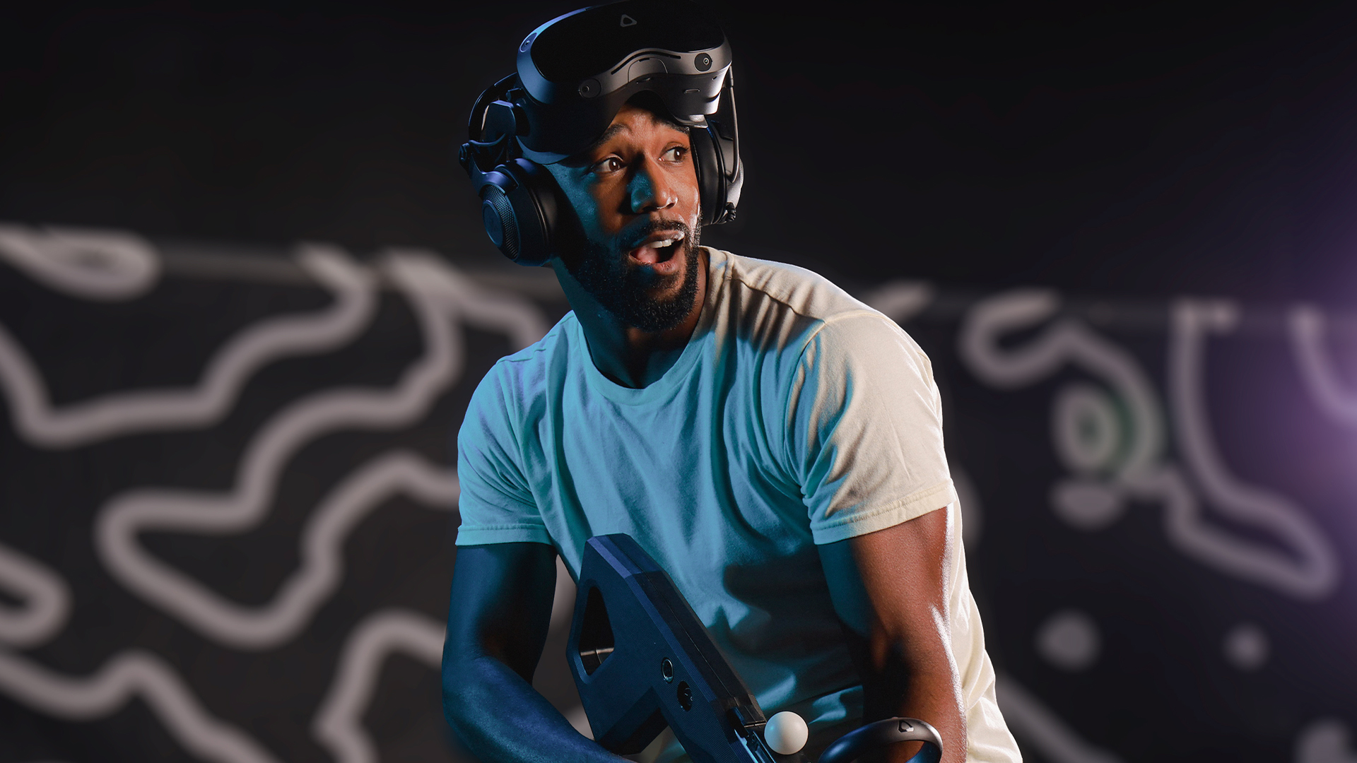 A Zero Latency VR player looking excited while holding a controller