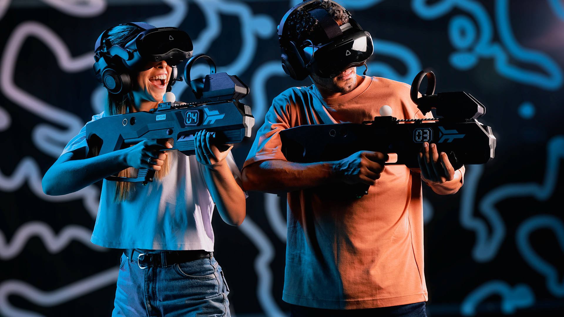 Two guests wearing VR headsets and holding Zero Latency VR controllers