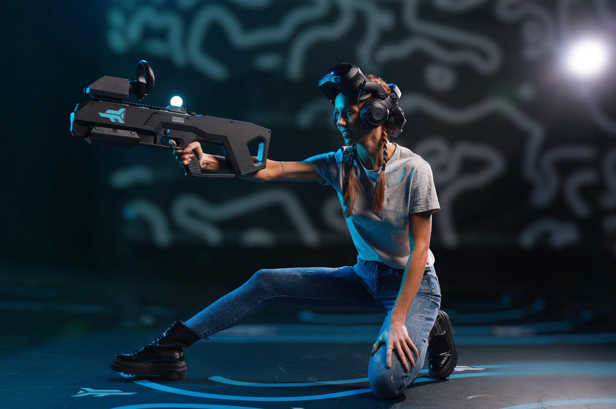 Zero Latency VR guest aiming a controller while kneeling in the arena